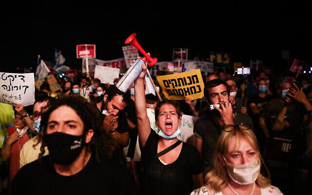 Des Israéliens protestent contre les dernières restrictions du gouvernement en matière de coronavirus à Tel Aviv, le 18 juillet 2020. (Miriam Alster/Flash90) Des Israéliens protestent contre les dernières restrictions du gouvernement en matière de coronavirus à Tel Aviv, le 18 juillet 2020. (Miriam Alster/Flash90)