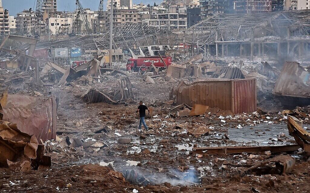 Des blessés marchent aux abords du site d'une explosion dans le port de la capitale libanaise Beyrouth, le 4 août 2020. (Crédit : STR / AFP)