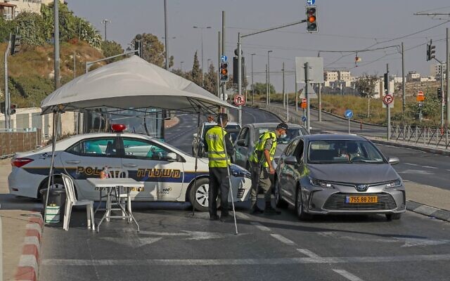 Des policiers israéliens arrêtent une voiture à un checkpoint à Jérusalem-Est pour faire appliquer le confinement national mis en place dans la lutte contre le coronavirus, le 25 septembre 2020 (Crédit : AHMAD GHARABLI / AFP) Des policiers israéliens arrêtent une voiture à un checkpoint à Jérusalem-Est pour faire appliquer le confinement national mis en place dans la lutte contre le coronavirus, le 25 septembre 2020 (Crédit : AHMAD GHARABLI / AFP)