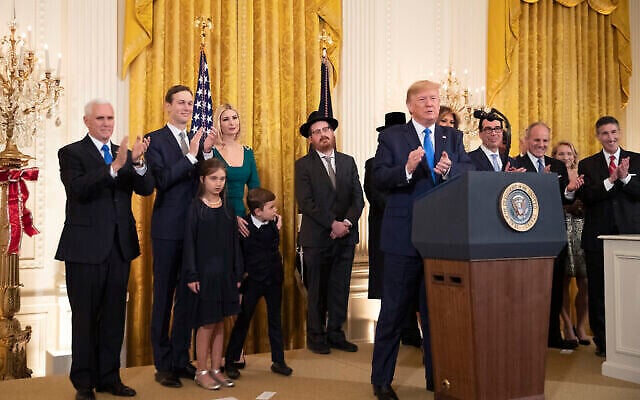 Le président américain Donald Trump en compagnie de la première dame Melania Trump, avec, de gauche à droite, le vice-président Mike Pence, Jared Kushner et Ivanka Trump et leurs enfants Arabella Kushner et Joseph Kushner, applaudissant lors d'une cérémonie pour la fête de Hanoukka dans la salle Est de la Maison Blanche, le 11 décembre 2019 à Washington. (AP/Manuel Balce Ceneta)