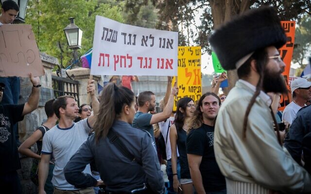 Des manifestants laïcs israéliens scandant des slogans lors d'une manifestation de Juifs ultra-orthodoxes contre les commerces qui ouvrent le samedi dans la ville, à Jérusalem, le 12 août 2017. Le slogan, qui rime en hébreu, dit : "Nous ne sommes pas contre le Shabbat, nous sommes contre la pression religieuse." (Crédit : Yonatan Sindel/Flash90) Des manifestants laïcs israéliens scandant des slogans lors d'une manifestation de Juifs ultra-orthodoxes contre les commerces qui ouvrent le samedi dans la ville, à Jérusalem, le 12 août 2017. Le slogan, qui rime en hébreu, dit : "Nous ne sommes pas contre le Shabbat, nous sommes contre la pression religieuse." (Crédit : Yonatan Sindel/Flash90)