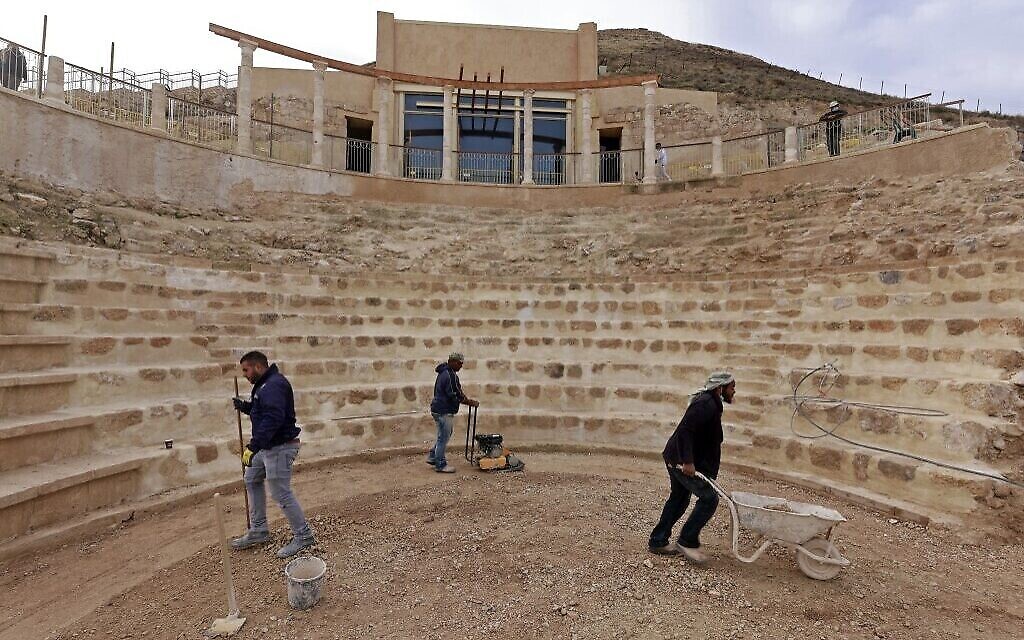 Des ouvriers aplanissant le sol restauré du théâtre antique construit par Hérode le Grand entre 23 et 15 avant notre ère, dans le désert de Judée, au sud-est de Bethléem, en Cisjordanie, le 7 décembre 2020. (Crédit : Menahem Kahana/AFP)