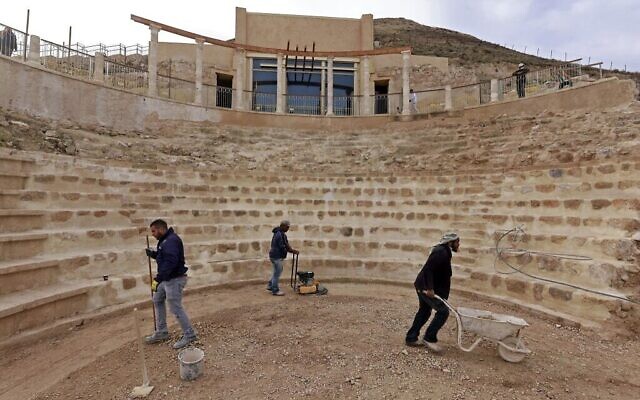Des ouvriers aplanissant le sol restauré du théâtre antique construit par Hérode le Grand entre 23 et 15 avant notre ère, dans le désert de Judée, au sud-est de Bethléem, en Cisjordanie, le 7 décembre 2020. (Crédit : Menahem Kahana/AFP)
