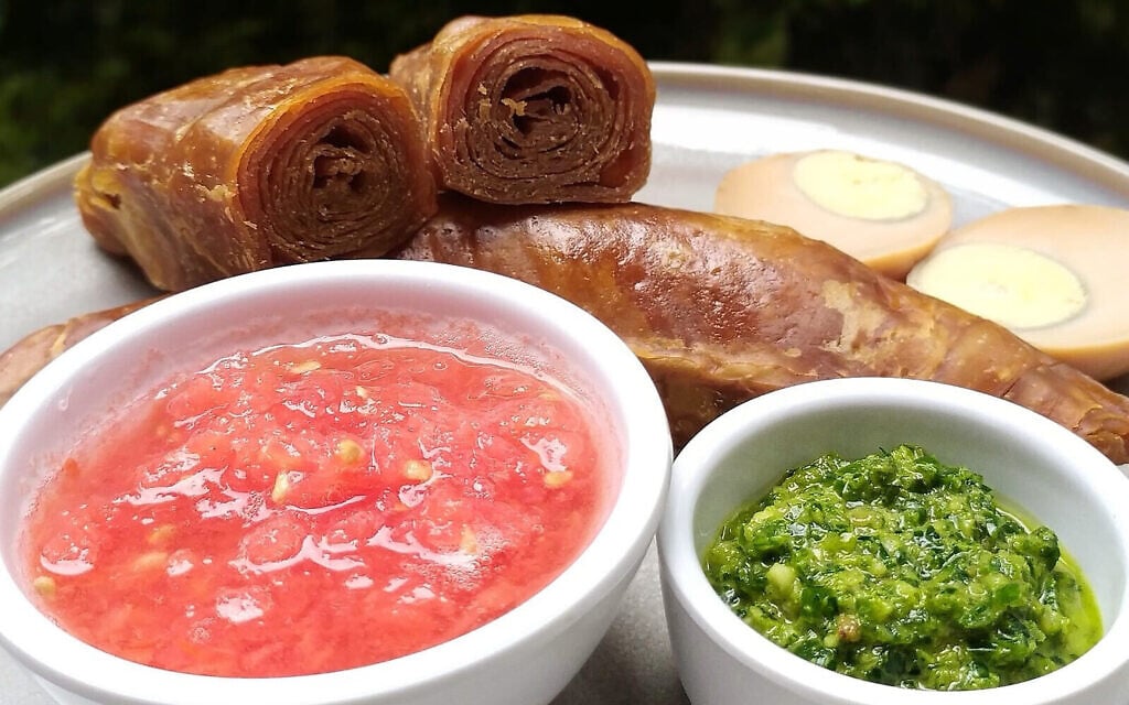 Servi avec de la tomate écrasée et du zhug, un pesto de coriandre épicé, le jachnun est un spécialité du week-end pour les Juifs yéménites. (Crédit : Gal Garber/ via JTA)