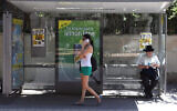 Illustration : Une femme parlant sur son téléphone portable à un arrêt de bus, à Tel Aviv, le 24 août 2012. (Crédit : Yaakov Naumi/Flash90)