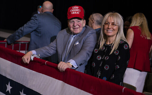 In this February 21, 2020, file photo businessman and Republican donor Sheldon Adelson (red hat) and wife Miriam wait for the arrival of then-US president Donald Trump to a campaign rally at the Las Vegas Convention Center in Las Vegas. (AP Photo/Evan Vucci, File)