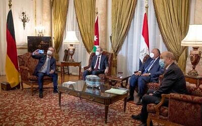 De gauche à droite, le ministre allemand des Affaires étrangères Heiko Maas, prend une photo de journalistes avec son téléphone portable, lors d'une réunion avec le ministre jordanien des Affaires étrangères Ayman Safadi, le ministre égyptien des Affaires étrangères Sameh Shoukry, et le ministre français des Affaires étrangères Jean-Yves Le Drian, avant une conférence de presse au Palais Tahrir, au Caire, en Égypte, le 11 janvier 2021. (AP Photo/Nariman El-Mofty)