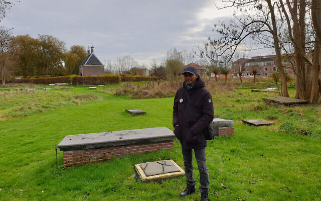 Sergio Berrenstein à côté de la tombe d'Elieser et de celle de son maître à l'entrée du cimetière juif d'Ouderkerk aan de Amstel, aux Pays-Bas, le 20 novembre 2020. (Autorisation : Cnaan Liphshiz/ JTA) Sergio Berrenstein à côté de la tombe d'Elieser et de celle de son maître à l'entrée du cimetière juif d'Ouderkerk aan de Amstel, aux Pays-Bas, le 20 novembre 2020. (Autorisation : Cnaan Liphshiz/ JTA)