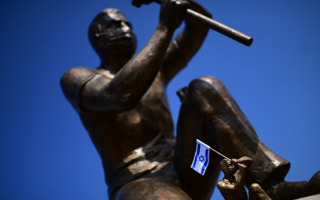 Une statue d'un manifestant anti-Netanyahu tient un drapeau israélien sur la place Rabin à Tel Aviv, le 18 décembre 2020. (Tomer Neuberg / Flash90) Une statue d'un manifestant anti-Netanyahu tient un drapeau israélien sur la place Rabin à Tel Aviv, le 18 décembre 2020. (Tomer Neuberg / Flash90)