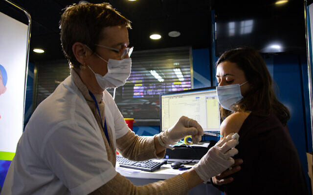 Une femme se fait vacciner contre la COVID-19 dans un centre de vaccination à Jérusalem, le 28 janvier 2021. (Crédit :  Olivier Fitoussi/Flash90)