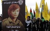 Des partisans du parti palestinien Fatah défilant avec une affiche de la terroriste Dalal al-Mughrabi, qui a participé au massacre de la route côtière en Israël en 1978, lors d'un rassemblement marquant le 55e anniversaire de la fondation du parti politique, dans la ville de Bethléem, en Cisjordanie, le 1er janvier 2020. (Crédit : Musa al-Shaer/AFP)