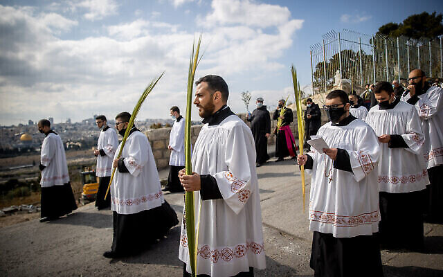 Des pélerins chrétiens participent à la procession traditionnelle des rameaux sur le mont des Oliviers à Jérusalem, le 28 mars 2021. (Crédit : Yonatan Sindel/Flash90) Des pélerins chrétiens participent à la procession traditionnelle des rameaux sur le mont des Oliviers à Jérusalem, le 28 mars 2021. (Crédit : Yonatan Sindel/Flash90)