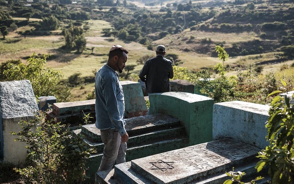 Sitotaw Alene (à droite) et Adamu Mengistu, dirigeants de la communauté juive éthiopienne, visitent le cimetière de la communauté à la périphérie de la ville de Gondar, en Ethiopie, le 26 octobre 2020. (Crédit : EDUARDO SOTERAS / AFP)