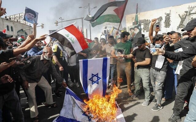 Des Irakiens ont mis le feu à des drapeaux israéliens lors d'un rassemblement, dans la capitale Bagdad le 15 mai 2021, à l'occasion du 73e anniversaire de la Nakba, la "catastrophe" que représente pour les Palestiniens, la création d'Israël en 1948. (Crédit : Ahmad AL-RUBAYE / AFP) Des Irakiens ont mis le feu à des drapeaux israéliens lors d'un rassemblement, dans la capitale Bagdad le 15 mai 2021, à l'occasion du 73e anniversaire de la Nakba, la "catastrophe" que représente pour les Palestiniens, la création d'Israël en 1948. (Crédit : Ahmad AL-RUBAYE / AFP)