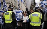 La police maintient un cordon de sécurité alors que des manifestants pro-israéliens se sont rassemblés aux abords de l'ambassade israélienne, dans le centre de Londres, le 23 mai 2021. (Crédit : Tolga Akmen/AFP)