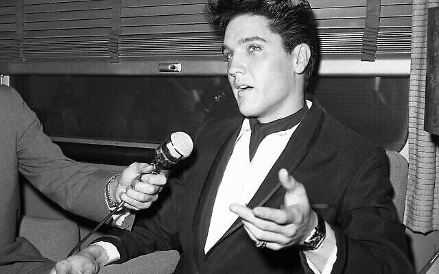 Le chanteur Elvis Presley en conférence de presse à l'intérieur de son wagon privé à la gare Union de Los Angeles, en Californie, aux États-Unis, à son arrivée le 20 avril 1960 pour tourner un film. (Crédit : AP Photo/HPM)