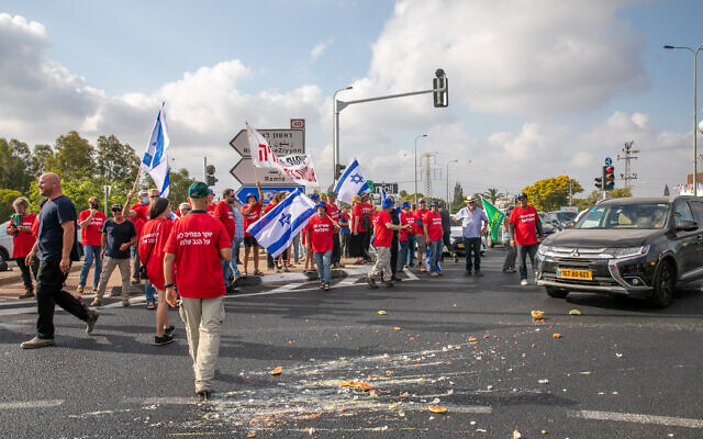 Des agriculteurs bloquent la jonction Bilu dans le cadre des manifestations organisées dans tout le pays contre le projet des ministères des Finances et de l'Agriculture d'ouvrir le marché des fruits et légumes à l'importation, le 29 juillet 2021. (Crédit : Yossi Aloni/Flash90)