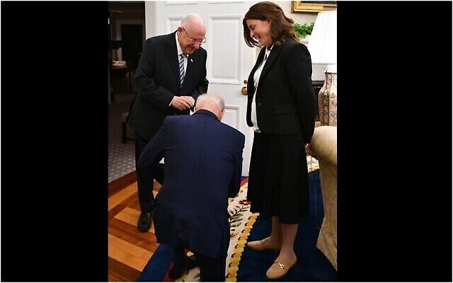 Le président américain Joe Biden s'agenouille devant Rivka Ravitz, chef de cabinet du président israélien Reuven Rivlin, après avoir appris qu'elle avait 12 enfants. (Haim Zach/GPO)