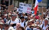 Un manifestant tient une pancarte indiquant "non au pass nazitaire" lors d'une manifestation contre la vaccination obligatoire contre la COVID-19 pour certains travailleurs et l'utilisation obligatoire du pass sanitaire réclamée par le gouvernement français, à Montpellier, le 31 juillet 2021. (Crédit : 
 Pascal GUYOT / AFP)