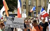 Une manifestation contre la vaccination obligatoire pour certains travailleurs et contre le pass sanitaire, à Metz, le 14 août 2021. (Crédit : JEAN-CHRISTOPHE VERHAEGEN / AFP )