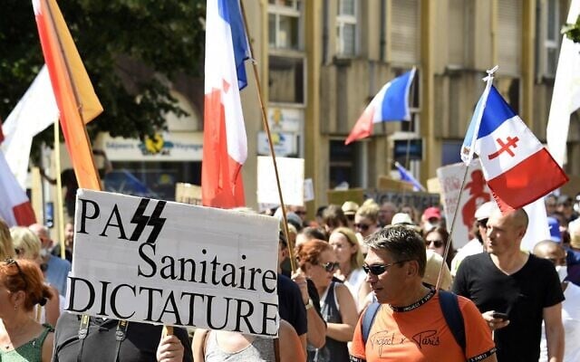 Une manifestation contre la vaccination obligatoire pour certains travailleurs et contre le pass sanitaire, à Metz, le 14 août 2021. (Crédit : JEAN-CHRISTOPHE VERHAEGEN / AFP ) Une manifestation contre la vaccination obligatoire pour certains travailleurs et contre le pass sanitaire, à Metz, le 14 août 2021. (Crédit : JEAN-CHRISTOPHE VERHAEGEN / AFP )