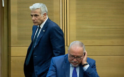 Le président d’Yisrael Beytenu, Avigdor Liberman (à droite) et le leader de Yesh Atid, Yaïr Lapid, lors de la première conférence gouvernementale dirigée par le Premier ministre israélien de l'époque, Naftali Bennett, à la Knesset, le 13 juin 2021. (Crédit : Yonatan Sindel/Flash90)