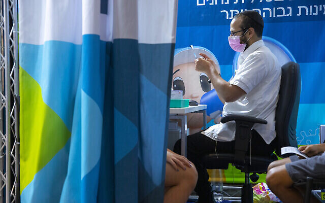 Un Israélien reçoit le vaccin COVID-19 le 20 septembre 2021 à Jérusalem (Olivier Fitoussi/Flash90) Un Israélien reçoit le vaccin COVID-19 le 20 septembre 2021 à Jérusalem (Olivier Fitoussi/Flash90)