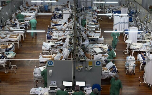 Des patients touchés par le COVID-19 dans un hôpital de campagne installé dans un gymnase, à Santo Andre, dans l'État de Sao Paulo (Brésil), le 26 mars 2021. (Crédit : Miguel SCHINCARIOL / AFP)