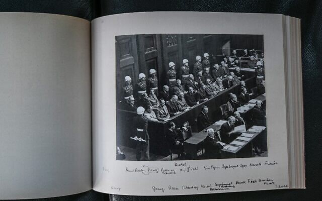 Un fac-similé d'un album photographique du procès de Nuremberg photographié le 13 octobre 2021 à l'Université de droit de Lyon 3 qui en possède une copie. Le musée mémorial d'Izieu (Ain) présente le 15 octobre 2021 une version réémergée et entièrement restaurée d'un album photographique du procès de Nuremberg, à l'occasion d'un colloque consacré aux audiences du tribunal militaire international historique. (Crédit : PHILIPPE DESMAZES / AFP) Un fac-similé d'un album photographique du procès de Nuremberg photographié le 13 octobre 2021 à l'Université de droit de Lyon 3 qui en possède une copie. Le musée mémorial d'Izieu (Ain) présente le 15 octobre 2021 une version réémergée et entièrement restaurée d'un album photographique du procès de Nuremberg, à l'occasion d'un colloque consacré aux audiences du tribunal militaire international historique. (Crédit : PHILIPPE DESMAZES / AFP)