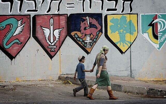 Des partisans du mouvement pro-implantation marchent devant une base militaire israélienne de Hébron qui sera partiellement détruite pour laisser la place à un complexe d'appartements pour les résidents d'implantation. (Crédit : Miriam Alster/Flash90)