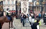 Capture d'écran de la vidéo d'un agent de la police métropolitainede Londres utilisant le langage des signes pour communiquer avec des touristes israéliens sourds devant le palais de Buckingham, le 3 octobre 2021. (Facebook)