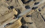 Des camions portant des plaques d'immatriculation égyptiennes et des excavatrices défrichent un terrain pour l'extension d'une route dans un site au nord de la ville de Gaza, le 30 octobre 2021. (Crédit : MOHAMMED ABED / AFP)