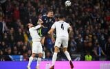 Scotland's striker Lyndon Dykes (center) heads the ball during the FIFA World Cup Qatar 2022 Group F qualification football match between Scotland and Israel at Hampden Park in Glasgow, on October 9, 2021. (Andy Buchanan/AFP)