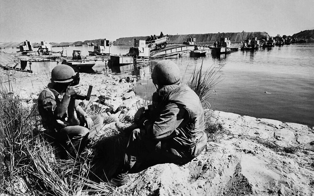 (FILES) In this file photo taken on October 6, 1973 Israeli troops cross the Suez Canal on October during the Yom Kippur war. - As the Suez Canal marks its 150th anniversary, Egypt which nationalised the crucial international waterway in 1956 can boast of its modern-day significance to the country's economy.  
The canal, which links the Mediterranean to the Red Sea, was opened to navigation in 1869 and was expanded in 2015 to accommodate larger ships. (Photo by - / AFP)
