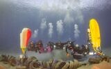 Des bénévoles de l'ONG Coast Patrol à  Eilat prennent la pose avec des pneus trouvés dans les fonds marins lors d'une opération de nettoyage annuelle. (Crédit : 'Amit Liber)