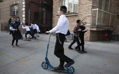 Illustration : Des enfants jouent sur un trottoir dans le quartier Williamsburg de Brooklyn, le 4 juin 2020 à New York, pendant la pandémie de coronavirus. (Crédit : AP Photo/Mark Lennihan)