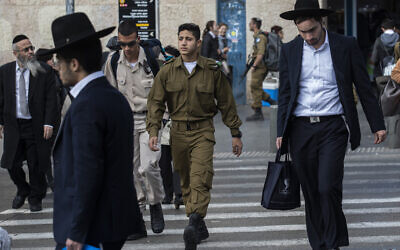 Illustration : Des hommes juifs ultra-orthodoxes marchant aux côtés de soldats israéliens, à Jérusalem, le 5 décembre 2019. (Crédit : Olivier Fitoussi/Flash90)