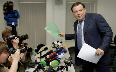 Le président de l'Alfa Group Mikhail Fridman, à droite, quitte une conférence de presse à Moscou, le 16 juin 2018. (Crédit :  AP Photo/Alexander Zemlianichenko)