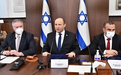Illustration : Le Premier ministre israélien Naftali Bennett, au centre, dirigeant la réunion du cabinet en présence du secrétaire général de l'OCDE Mathias Cormann, à sa gauche, au bureau du Premier ministre à Jérusalem, le 13 février 2022. (Crédit : Haim Zach/GPO)