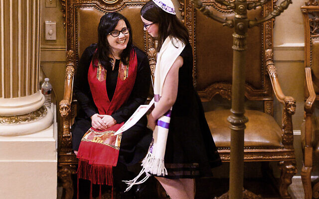 Illustration : Le rabbin Jacqueline Mates-Muchin sourit à Hanna Raskin lors de sa bat mitzvah au Temple Sinai à Oakland, en Californie, le 1er février 2020(Crédit : AP/Noah Berger)