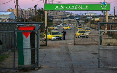 Des travailleurs palestiniens au poste-frontière d'Erez, dans le nord de Gaza, attendent d'entrer en Israël pour y travailler, le 13 mars 2022. (Crédit : Attia Muhammed/Flash90)