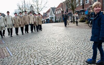 Un petit garçon s'approche du chœur qui mène la procession d' Ootmarsum, aux Pays-Bas, le 1er avril 2018. (Crédit : Romy Arroyo Fernandez/NurPhoto via Getty Images via JTA)