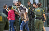 People leave the Uvalde Civic Center following a shooting earlier in the day at Robb Elementary School, Tuesday, May 24, 2022, in Uvalde, Texas. (William Luther/The San Antonio Express-News via AP)