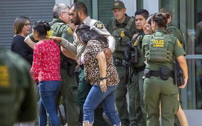 People leave the Uvalde Civic Center following a shooting earlier in the day at Robb Elementary School, Tuesday, May 24, 2022, in Uvalde, Texas. (William Luther/The San Antonio Express-News via AP)