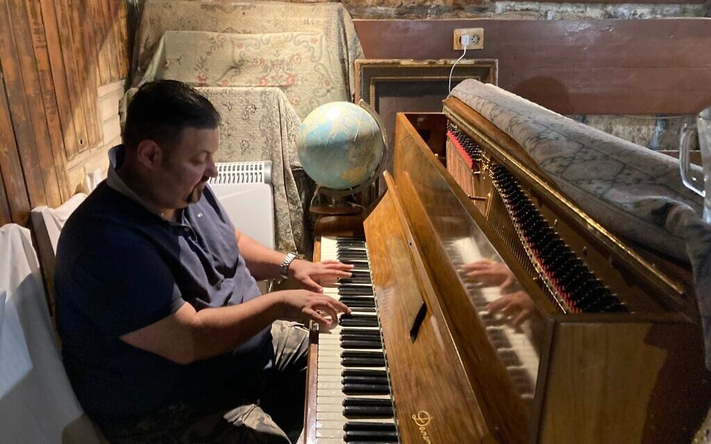 Le pianiste Bela Feher joue au Giero Pub, à Budapest, le 16 mai 2022. (Crédit : Yaakov Schwartz/Times of Israel) 
