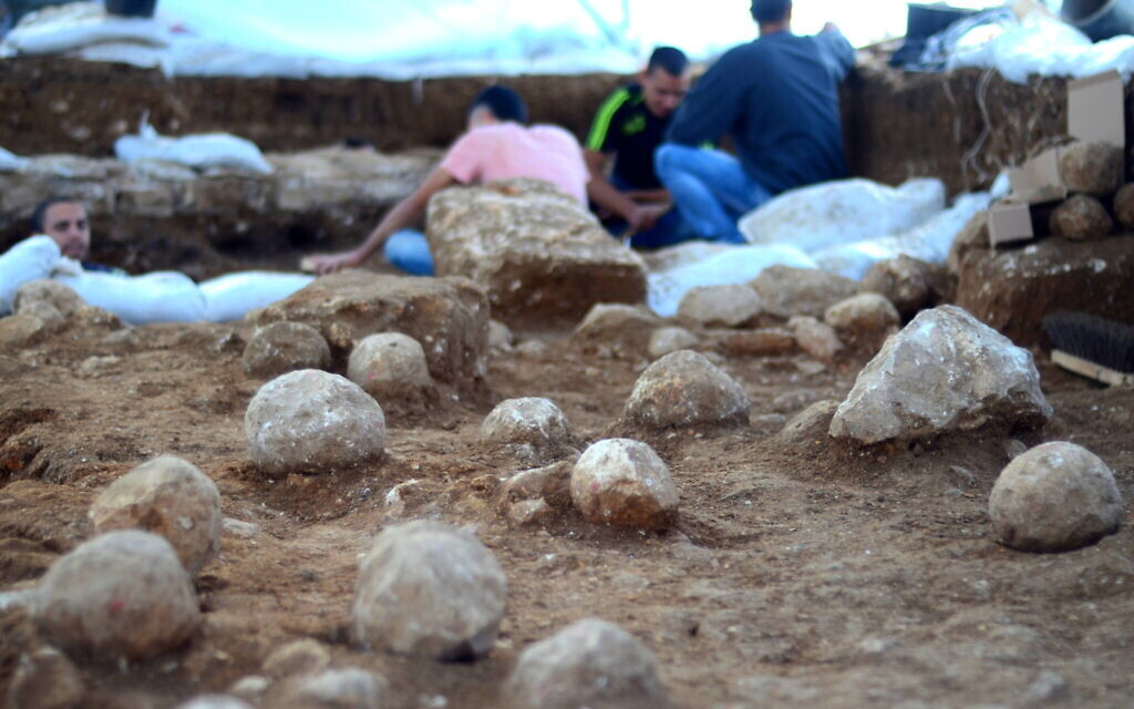 Le site de fouilles du Russian Compound à Jérusalem. Des pierres de baliste vieilles de 2000 ans, datant de la conquête romaine de l'an 70 de notre ère, sont visibles sur le sol. (Crédit : Yoli Schwartz/Autorité des antiquités d'Israël)