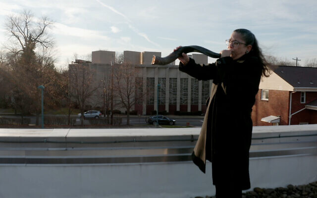 Audrey Glickman, une survivante de la fusillade de 2018 dans la synagogue Tree of Life à Pittsburgh, soufflant le shofar à l'extérieur du bâtiment dans le nouveau documentaire de HBO "A Tree of Life". (Crédit : HBO) Audrey Glickman, une survivante de la fusillade de 2018 dans la synagogue Tree of Life à Pittsburgh, soufflant le shofar à l'extérieur du bâtiment dans le nouveau documentaire de HBO "A Tree of Life". (Crédit : HBO)