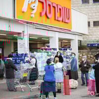 Illustration : Des personnes patientent devant un supermarché Shufersal à Safed le 6 avril 2020. (Crédit: David Cohen/Flash90)