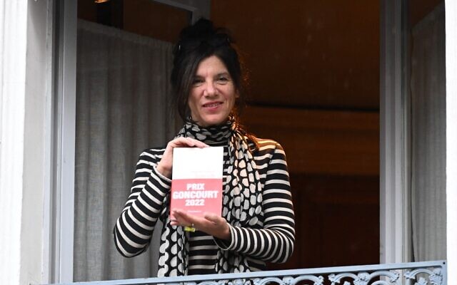 L'écrivain français Brigitte Giraud tient son roman à la fenêtre du restaurant Drouant après avoir reçu le prestigieux prix littéraire Goncourt pour son roman "Vivre Vite" (Flammarion) à Paris, le 3 novembre 2022. (Crédit : Bertrand GUAY / AFP) L'écrivain français Brigitte Giraud tient son roman à la fenêtre du restaurant Drouant après avoir reçu le prestigieux prix littéraire Goncourt pour son roman "Vivre Vite" (Flammarion) à Paris, le 3 novembre 2022. (Crédit : Bertrand GUAY / AFP)