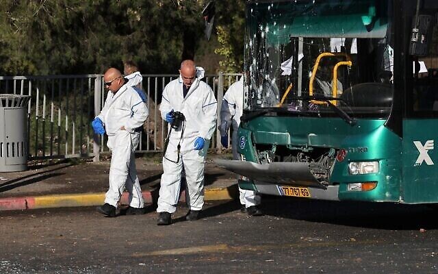 Des médecins légistes suite à un attentat terrorsite à un arrêt de bus, à Jérusalem, le 23 novembre 2022. (Crédit : Ahmad Gharabli/AFP) Des médecins légistes suite à un attentat terrorsite à un arrêt de bus, à Jérusalem, le 23 novembre 2022. (Crédit : Ahmad Gharabli/AFP)